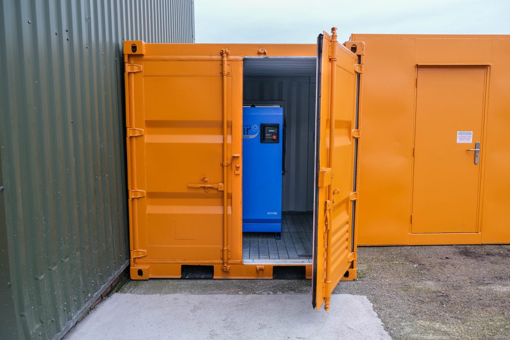 Orange 10ft Container storing an air compressor